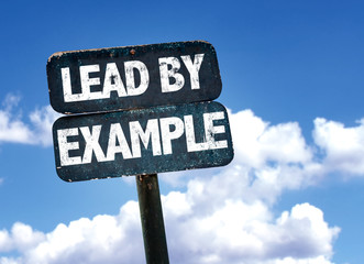 Lead By Example sign with sky background