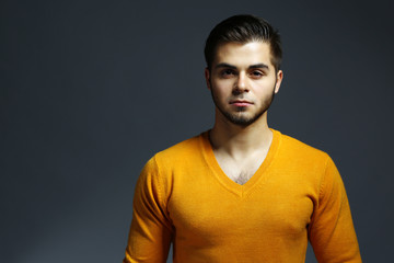 Portrait of young man on gray background