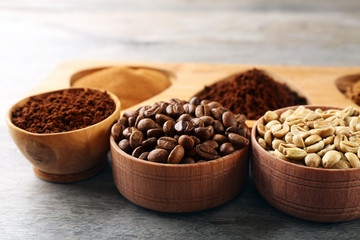 Various of coffee in small dishes on wooden table, closeup