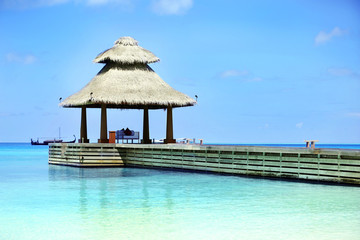 Boardwalk to arbor over blue ocean in Baros Maldives