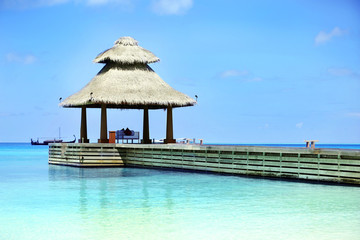 Boardwalk to arbor over blue ocean in Baros Maldives