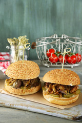 Tasty sandwich on cutting board, on color wooden background. Unhealthy food concept