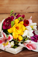 Beautiful spring flowers on wooden background