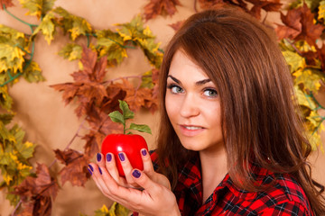 Cute young woman holding an apple