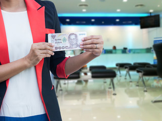 banking business concept ,young businessman hold money in your h