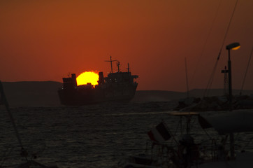 A cargo ship leaves Naxos at sunset_I