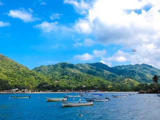 boats and parasailing at blue mexican beach
