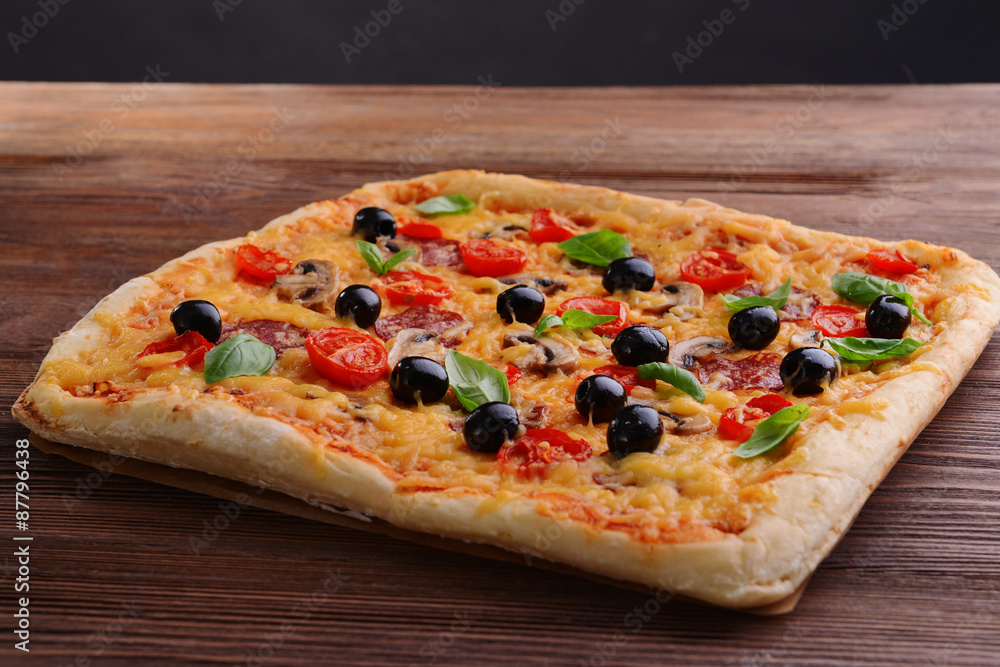 Sticker delicious homemade pizza on table on black background