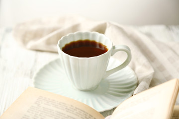 Still life with cup of coffee and book, close up