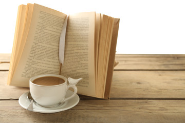 Still life with cup of coffee and book on wooden table, on white background