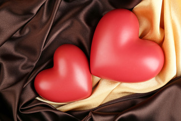 Red hearts on fabric background