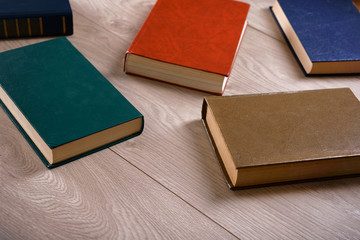Heap of books on wooden background