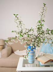 Spring bouquet in vase, on table, on home interior background