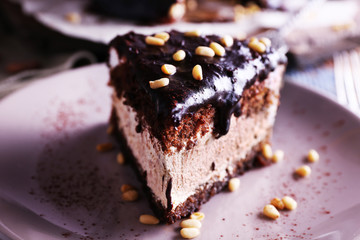 Delicious chocolate cake with icing in plate on table, closeup