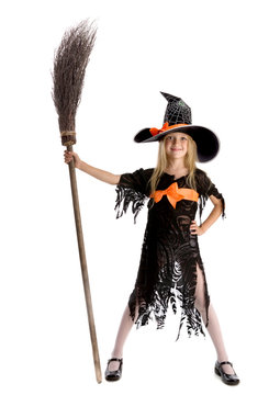Little happy witch holding a broom.