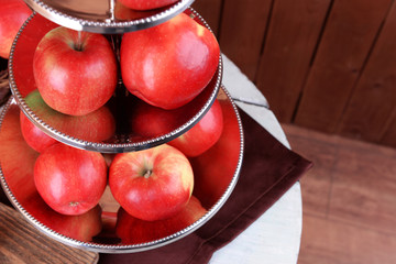 Tasty ripe apples on serving tray on table close up
