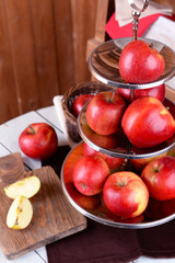 Tasty ripe apples on serving tray on wooden background