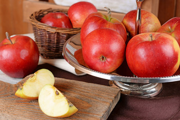 Tasty ripe apples on serving tray on table close up