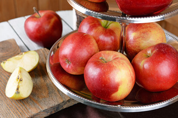 Tasty ripe apples on serving tray on table close up