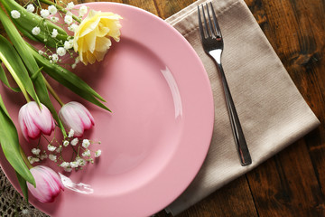 Tableware with flowers on table close up