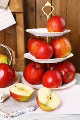 Tasty ripe apples on serving tray on table close up