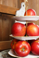 Tasty ripe apples on serving tray on wooden background
