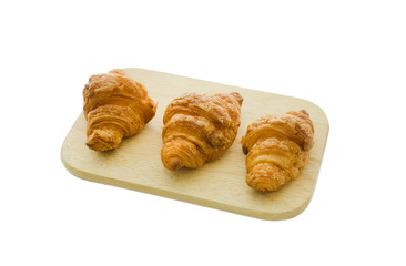 croissant on wood board