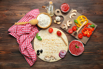 Ingredients for cooking pizza on wooden table, top view