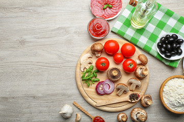 Ingredients for cooking pizza on wooden table, top view