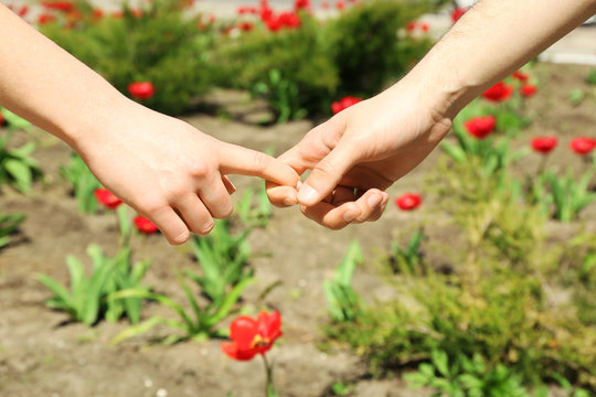 Couple holding hands on blurred background