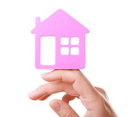 Female hand with small model of house isolated on white