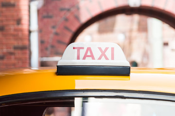 Taxi sign on roof top car