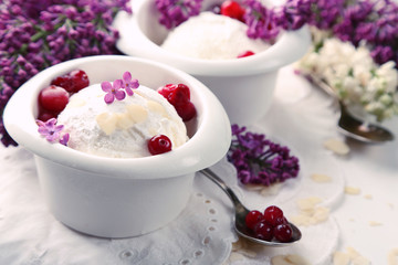 Beautiful composition with tasty ice cream and lilac flowers