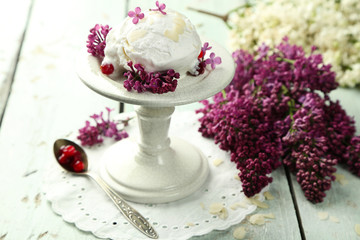 Beautiful composition with tasty ice cream and lilac flowers