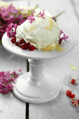 Beautiful composition with tasty ice cream and lilac flowers