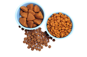 Blue ceramic dogs bowl. Dry dog food in bowl isolated on white background.