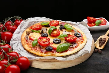 Foto op Plexiglas Tasty pizza with vegetables and basil on black background © Africa Studio