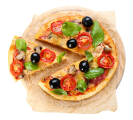 Tasty pizza with vegetables and basil on cutting board isolated on white