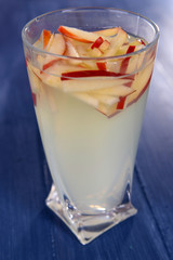 Glass of apple cider on wooden background