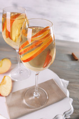 Glasses of apple cider with fruits on table close up