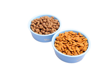 Blue ceramic dogs bowl. Dry dog food in bowl isolated on white background.