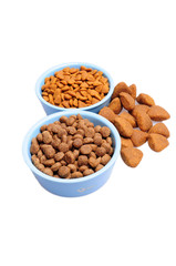 Blue ceramic dogs bowl. Dry dog food in bowl isolated on white background.
