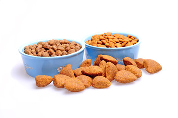 Blue ceramic dogs bowl. Dry dog food in bowl isolated on white background.
