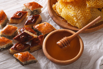 Oriental sweets: baklava with poppy and nuts and a honeycomb. 
