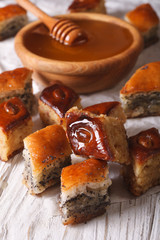 Baklava Honey with poppy seeds and nuts close-up. vertical
