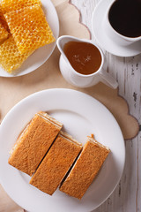 honey cake close-up, coffee, and a honeycomb. vertical top view
