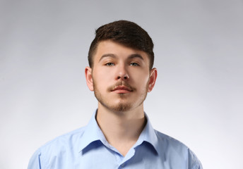 Portrait of serious man on gray background