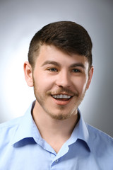 Portrait of smiling man on gray background