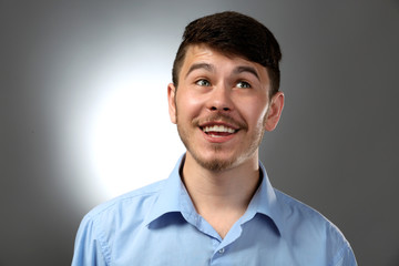 Portrait of smiling man on gray background