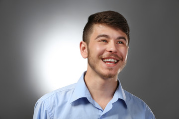 Portrait of smiling man on gray background